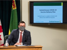 Health Minister Paul Merriman unveiling at the legislature last December a COVID-19 vaccine reduction strategy.