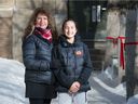 Cristina Ruiu, left, and her daughter Victoria Bateman stand outside Holy Rosary School in Regina, Saskatchewan, Feb. 2, 2021. Ruiu is president of the Holy Rosary School Parent Council, which calls on the school division to keep the school open.