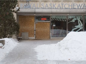 A door and a window can be seen boarded up at the Royal Saskatchewan Museum in Regina, Saskatchewan on Feb. 17, 2021. The Regina Police Service says a man crashed a vehicle into the museum on Tuesday evening and they anticipate charges to be laid in relation to the matter.