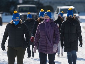 A group of people participate in the annual Coldest Night of the Year event by walking through Wascana Park in Regina, Saskatchewan on Feb. 20, 2021. This year's event, hosted by the YWCA, is intended to raise money for My Aunt's Place, which is Regina's only homeless shelter for women and children.