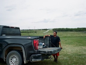 Lindsay Littlechief, 39, of Ocean Man First Nation stands in the foreground of the large oil spill that happened on the band's land in 2017. Littlechief has been working in the oil sector since 2006.