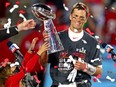 Tampa Bay Buccaneers quarterback Tom Brady (12) celebrates with the Vince Lombardi Trophy after beating the Kansas City Chiefs in Super Bowl LV at Raymond James Stadium.