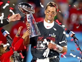 Tampa Bay Buccaneers quarterback Tom Brady (12) celebrates with the Vince Lombardi Trophy after beating the Kansas City Chiefs in Super Bowl LV at Raymond James Stadium.