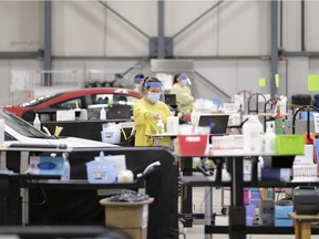 Covid testing and assessment staff work at the COVID-19 drive-thru test site at International Trade Centre in Regina on Thursday Feb. 18, 2021. Once enough vaccinations arrive, the site will become an drive-thru immunization site.