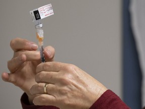 A syringe with the Pfizer-BioNTech COVID-19 vaccine is prepared at the Regina General Hospital in Regina on Tuesday Dec. 15, 2020.