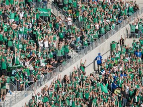 Roughriders fans cheer during a game against the Winnipeg Blue Bombers at Mosaic Stadium.
