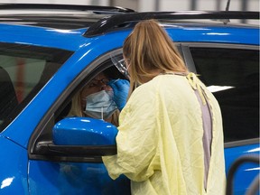 REGINA, SASK : September 8, 2020  -- A health worker demonstrates how a COVID-19 swab test would be conducted at the Saskatchewan Health Authority drive-thru COVID-19 testing facility in Regina, Saskatchewan on Sept. 8, 2020. BRANDON HARDER/ Regina Leader-Post