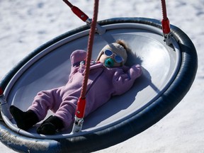Nine-month-old Indie swings in the sunshine at Ashley Park. Photo taken in Saskatoon on March 4, 2021.