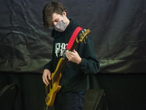 Brennan Koshykowski playing bass guitar during a practice at the School of Rock in Regina on March 6, 2021.