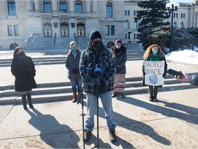 Prescott Demas speaks to media during a gathering in front of the Saskatchewan Legislative Building in Regina on March 11, 2021.