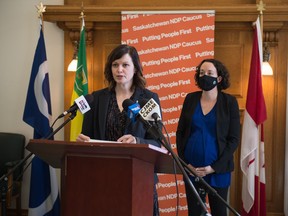 Vicki Mowat, the NDP MLA for Saskatoon-Fairview, speaks to media during a news conference in the Saskatchewan Legislative Building in Regina, Saskatchewan on Mar. 11, 2021. NDP MLA Nicole Sarauer is seen on the right.