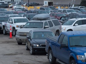 Motorists sit in lineups waiting to receive the COVID-19 vaccine at Evraz Place in Regina, Saskatchewan on March 16, 2021.
