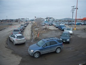Motorists sit in lineups waiting to receive the COVID-19 vaccine at Evraz Place in Regina, Saskatchewan on March 16, 2021.