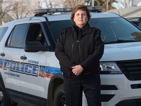 Insp. Audra Young, inspector in charge of north district, overseeing Traffic Safety unit and Combined Traffic Safety Services unit and Crime Stoppers for the Regina Police Service stands in front of a police vehicle in the compound behind police headquarters in Regina on March 18, 2021.