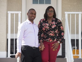 Victor Ejike, left, and Amarachi Ejike stand in front of their home in Regina, Saskatchewan on March 27, 2021. The pair are the owners of Cynogren Media and producers of upcoming show Another View.