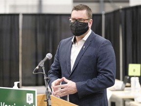 Paul Merriman, minister of health, speaks to media after a tour of the COVID-19 mass immunization clinic and drive-thru immunization space at International Trade Centre in Regina on Thursday Feb. 18, 2021.