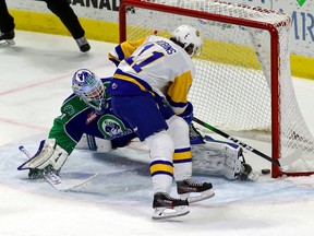 The Saskatoon Blades' Tristen Robins, 11, scores Wednesday's overtime winner on Swift Current Broncos goalie Isaac Poulter at the Brandt Centre.