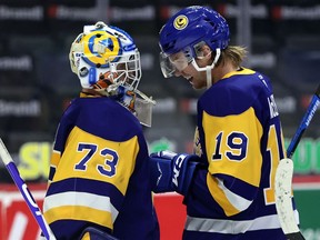 Saskatoon Blades goalie Nolan Maier (73) is congratulated by defenceman Wyatt McLeod (19) after Monday's 4-0 victory over the Prince Albert Raiders at the Brandt Centre.