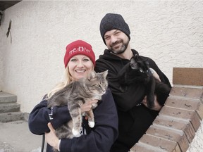 Kristina Gasparic-Block and Stu Block hold their cats Joey and BooBoo at their home in east Regina.