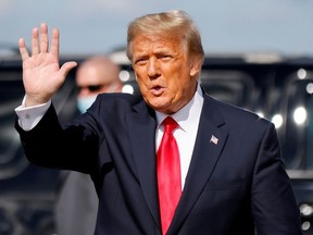 U.S. President Donald Trump waves as he arrives at Palm Beach International Airport in West Palm Beach, Florida, U.S., January 20, 2021.