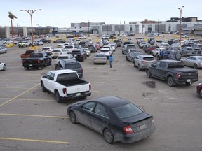 Vehicles line up at Evraz Place in Regina for the drive-thru vaccination clinic, which is distributing the  AstraZeneca vaccine to people aged 64.