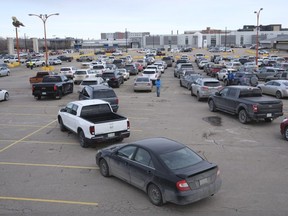 Vehicles line up at Evraz Place in Regina for the drive-thru vaccination clinic.