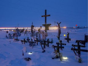 Light trails from a vehicle are seen in a long exposure of the memorial for the Humboldt Broncos bus crash at the intersection of highways 35 and 335 inside the the Rural Municipality of Connaught, Sask. on Thursday, Jan. 31, 2019.