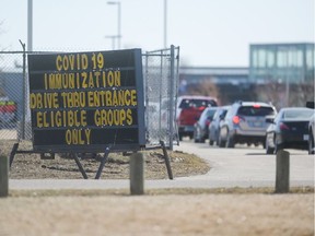 Vehicles line up at Evraz Place in Regina for the drive-thru vaccination clinic.