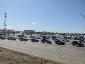 Hundreds of people line up to receive their COVID-19 vaccine at the Praireland Park drive-thru clinic on Monday morning.