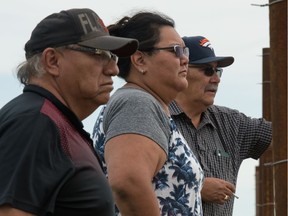 From left, bison caretaker Bruce Cappo, Muscowpetung First Nation Chief Melissa Tavita, and Muscowpetung public safety security and fire officer Jim Pratt look through the fence at the newly erected bison farm being run on Muscowpetung First Nation on July 29, 2020. BRANDON HARDER files