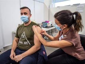 Dr. Hassan Masri receives the first shot of a two-dose COVID-19 vaccine in Saskatoon on Dec. 22. He was among the first in the city to get the jab.