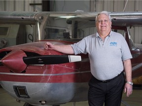 Gary Williams, Regina-based national president of the Canadian Aviation Historical Society, stands next to a Cessna 150 airplane in the hanger at Prairie Flying Service in Regina, Saskatchewan on April 1, 2021.