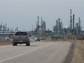 Vehicles drive down McDonald Street toward the Co-op Refinery Complex in Regina, Saskatchewan on April 8, 2021. Turnaround is in full swing after it was postponed during to the lockout and COVID-19 in 2020. Despite the increased of COVID-19 Variants of Concern out of city and out of province workers have come to the city for the maintenance.