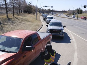 Drivers queue for a chance to get the Pfizer-BioNTech COVID-19 vaccine at Evraz Place. The vaccine was available today to 53 and 54-year-olds.