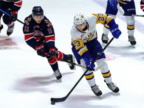 Regina Pats' Carter Massier (11) checks Saskatoon Blades' Evan Patrician (23) at the Brandt Centre on April 15, 2021. (Keith Hershmiller Photography)