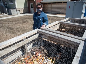 Ruth Blaser, a member of Prairie Spruce Commons Co-housing, stands next to the compost bins outside the facility in Regina on April 22, 2021.