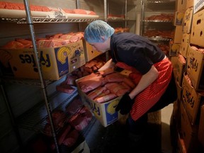 Butcher Allan vande Bruinhorst freezes beef as part of his uncle's business which allows farmers to circumvent the supply chain blockage caused by coronavirus disease (COVID-19) outbreaks at meatpacking plants, in Picture Butte, Alberta, Canada June 17, 2020.