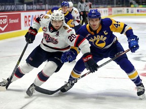 Regina Pats' Kyle Walker (20) and Saskatoon Blades captain Chase Wouters (44) on April 20, 2021 at the Brandt Centre. Keith Hershmiller Photography.