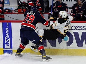 Regina Pats' Logan Nijhoff delivers a hit on the Brandon Wheat Kings' Nate Danielson during WHL action at the Brandt Centre on Thursday. Keith Hershmiller Photography.