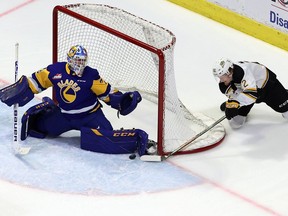 Saskatoon Blades goaltender Nolan Maier stops a wrap-around attempt by the Brandon Wheat Kings' Ben McCartney (22) on Sunday at the Brandt Centre.