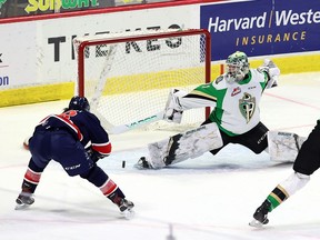 The Regina Pats' Cole Dubinsky (left) scores on Prince Albert Raiders goalie Max Paddock on April 19, 2021 at the Brandt Centre. Keith Hershmiller Photography.