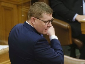 Premier Scott Moe removes his mask to speak during Question Period on Budget Day at the Legislative Building in Regina on Tuesday April 6, 2021. The government presented a budget with both record spending and deficits.