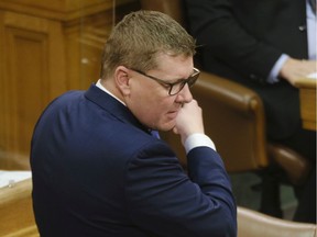 Premier Scott Moe removes his mask to speak during question period on budget day at the Legislative Building in Regina on April 6, 2021.