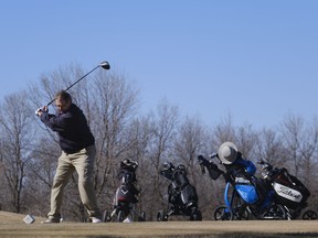 Dan Petrowsky tees-off during the opening day of golf at Tor Hills Golf Course. Courses normally open in May, but warm weather and below average spring runoff allowed for an earlier opening.
