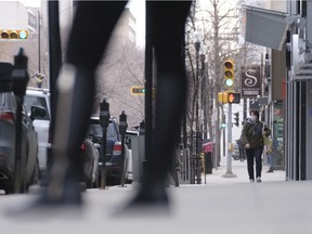A pedestrian walks downtown on a nearly empty Hamilton Street on March 24, 2021.