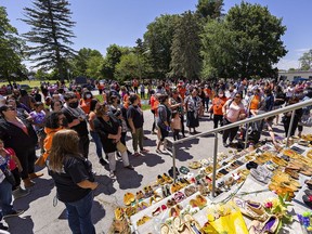 A large group gathered in front of the Mohawk Institute, a former residential school in Brantford, Ontario on Sunday afternoon May 30, 2021. Pairs of moccasins were placed on the steps to honour the memory of the lives of 215 children whose remains were discovered in a mass grave at a Kamloops (B.C.) Indian Residential School. Brian Thompson/Brantford Expositor/Postmedia Network