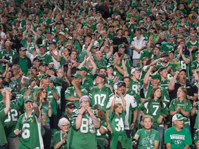 Saskatchewan Roughriders fans cheer during a game against the Hamilton Tiger-Cats at Mosaic Stadium.