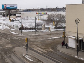 A group of people gather on an otherwise-empty street in Saskatoon in April 2020.