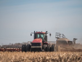 A seeder plants wheat in a field near Saskatoon, SK on Tuesday, April 27, 2021.
