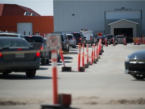 Vehicles line up for the drive-thru COVID-19 vaccine clinic at Evraz Place in Regina, Saskatchewan on May 4, 2021, when age eligibility became anyone 37 or older.